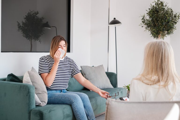 Young woman crying and receiving psychological assistance. Concept: health care, mental health